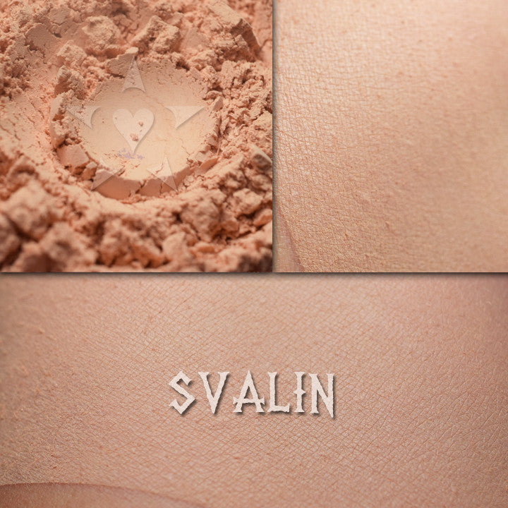 Svalin matte eyeshadow shown loose and swatched on the skin.  A pale golden peach matte