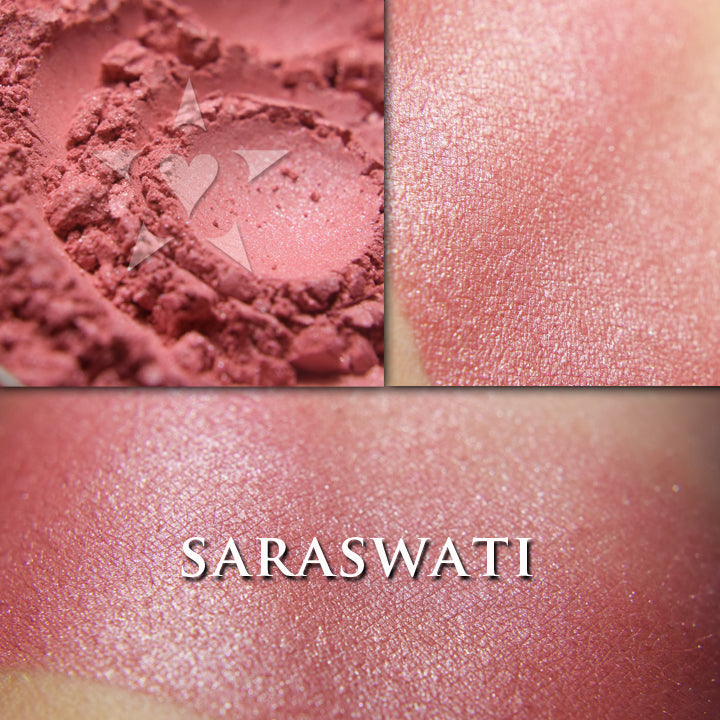 Saraswati loose and swatched on the skin. Saraswati is a rich muted coral red with some shimmer. 