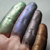 Green, blue, gray and brown frost eyeshadows shown swatched on the fingertips.