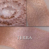 Terra highlighter loose and swatched on the skin.  a very pretty neutral with peach tones and borealis shimmer. 
