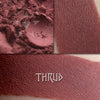 Thrud matte eyeshadow shown loose and swatched on the skin.  Deep brownish red