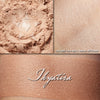 Thyatira illuminator loose and swatched on the skin. A muted peachy buff