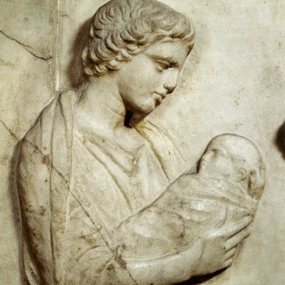 Image shows a bas relief sculpture of a woman holding a swaddled baby. She is Agnodice, who this eyeshadow is named after.