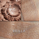 BRILLA - Multipurpose Illuminator loose and swatched on the skin. BRILLA- A warm toned buff with hints of pinky peach.