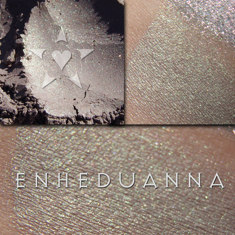 ENHEDUANNA eyeshadow shown loose and swatched on the skin.  beautiful complex neutral. It can appear a soft taupe grey with soft green highlights