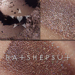HATSHEPSUT eyeshadow loose and swatched on the skin.  a rich, deep brown with undertones of eggplant and dark violet. The interplay of multichromal color within this base can only be described as a rainbow.