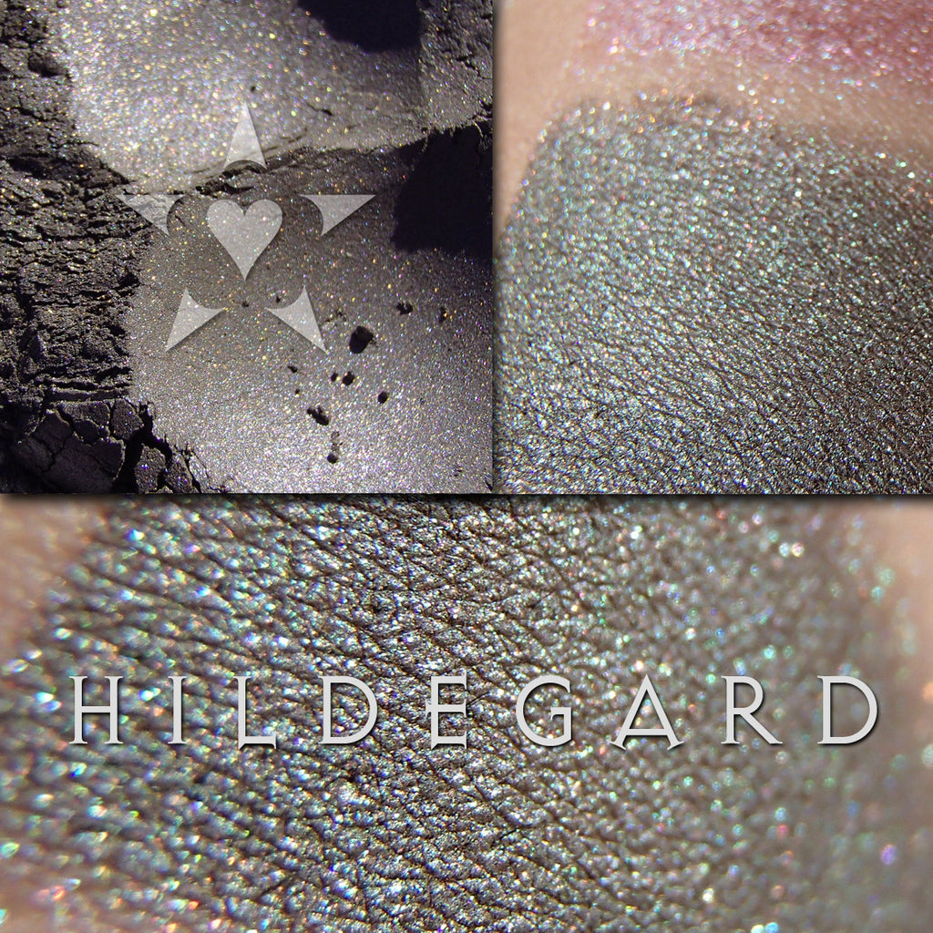 HILDEGARD eyeshadow loose and swatched on the skin. a deep evergreen-pewter with aqua/green/blue tonal effects and subtle metallic green shimmer.