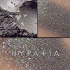 HYPATIA eyeshadow loose and swatched on the skin.  a very complex shade, with several layers of multichromal effect, to depict Hypatia's many studies. At it's core, it is a neutral grey- but it changes tone in different types of light!