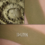 IDUNN matte finish eyeshadow shown loose and swatched on the skin. A midtone warm green with brown tones- matte