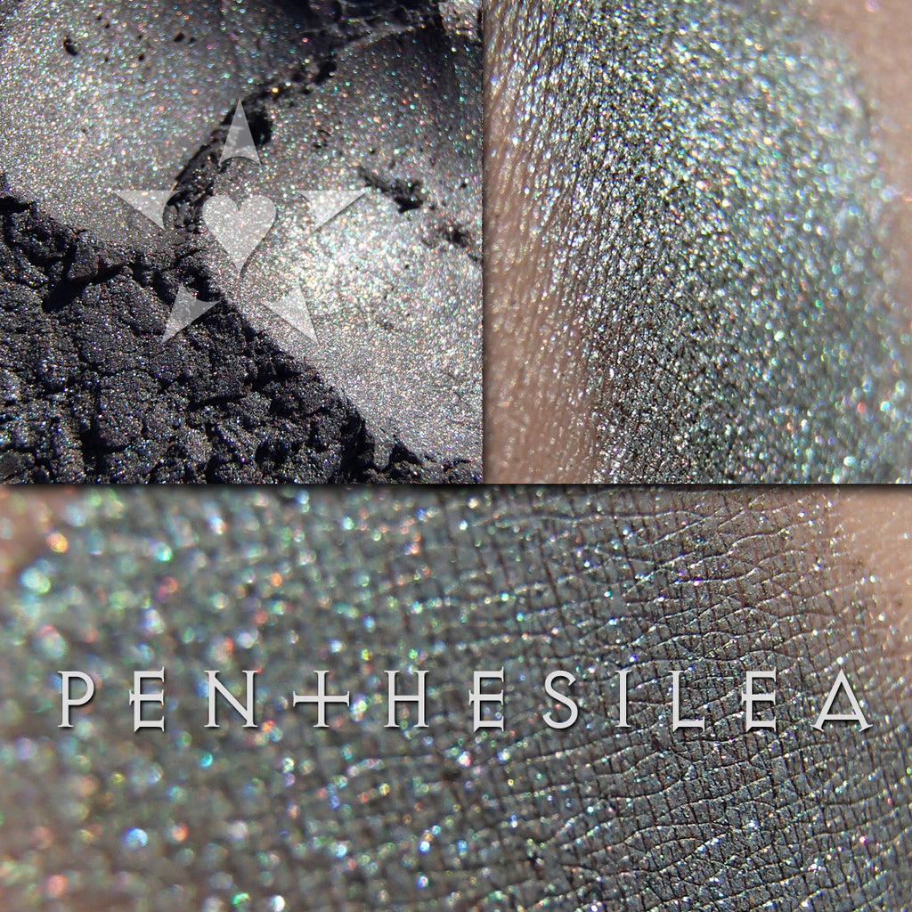 PENTHESILEA eyeshadow shown loose and swatched on the skin. Penthesilea is a rich dark greenish patina with multichrome effects of violet-red and gold-chartreuse.