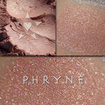 PHRYNE eyeshadow shown loose and swatched on the skin. A beautiful coral with strong gold and copper chrome effects.