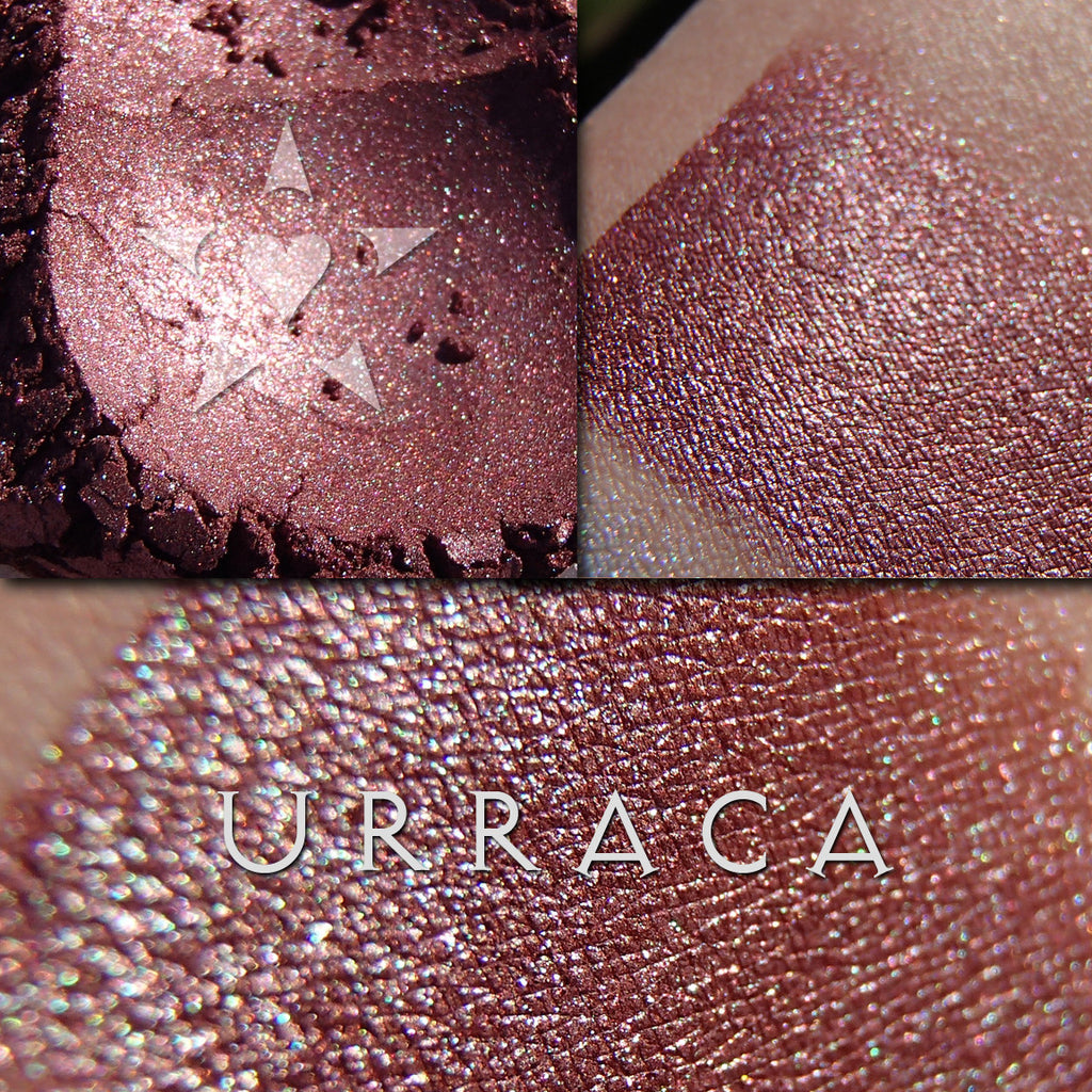 URRACA eyeshadow loose and swatched on the skin. Urraca is a rich bordeaux with mahogany undertones, and complex highlights of gold, green and blue.